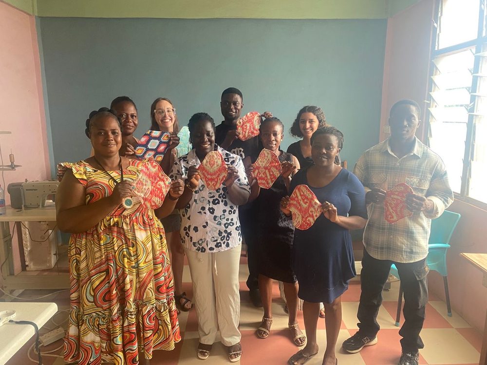 Community members holding reusable cloth menstrual pads