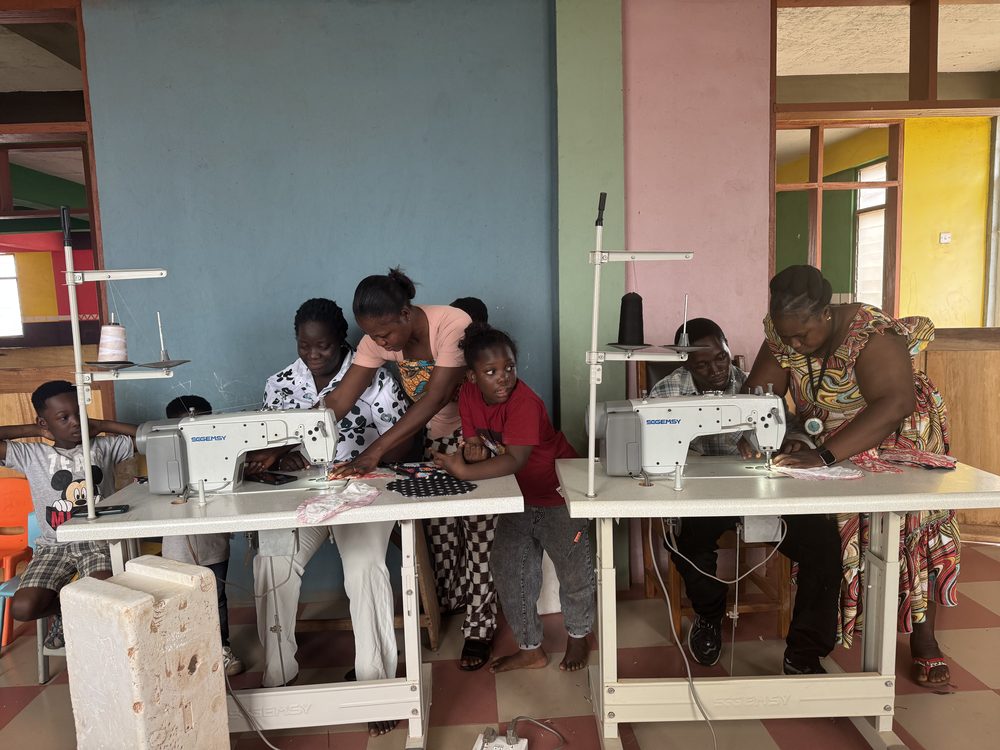 Women learning to sew at sewing machines in Senase